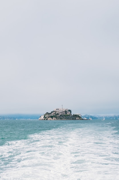 A vertical shot of an island in the middle of the sea