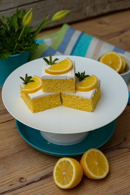 Vertical shot of lemon cake pieces on a white plate