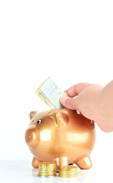 Vertical shot of a man saving dollars on the cashbox in the white background