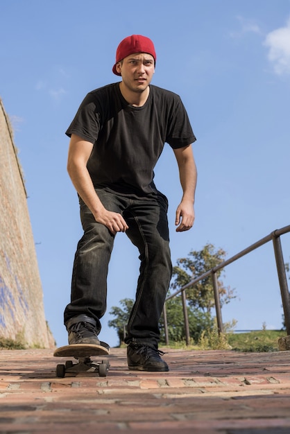 Free photo vertical shot of a man skateboarding outside