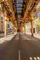 Free photo vertical shot of the monorail bridge above a street captured on a sunny day in chicago