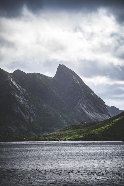 Vertical shot of the mountains and a lake in the lofoten islands