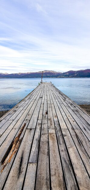 Vertical shot of an old wooden dock in the sea