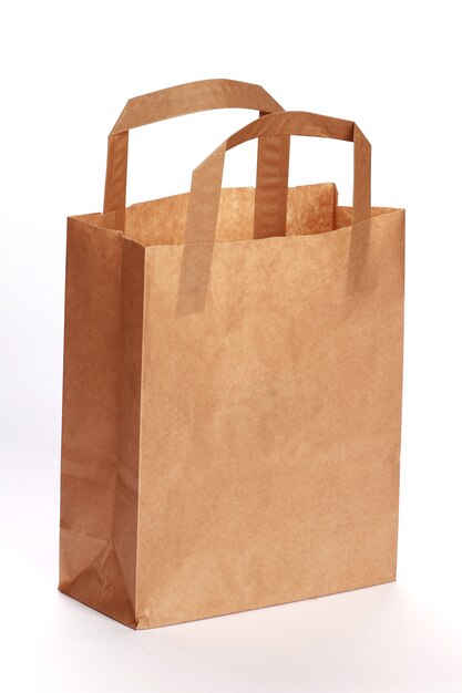 Vertical shot of a paper bag isolated on a white room