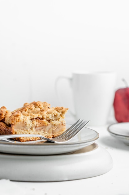 Vertical shot of a piece of crispy pie in a plate on the table