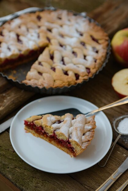 Vertical shot of a piece of homemade apple pie on a white plate