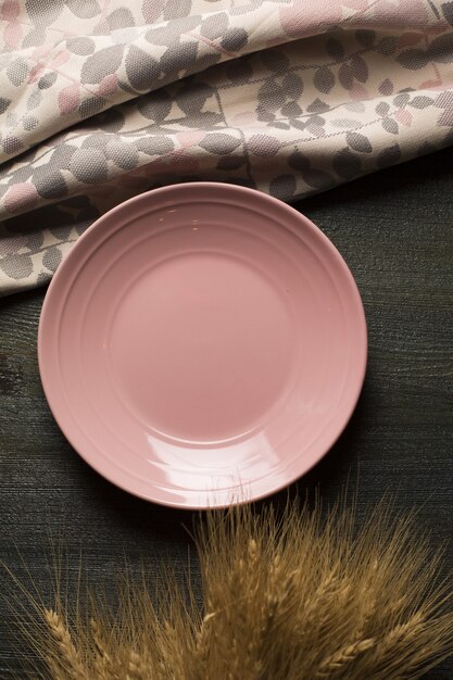 Vertical shot of a pink plate on a table