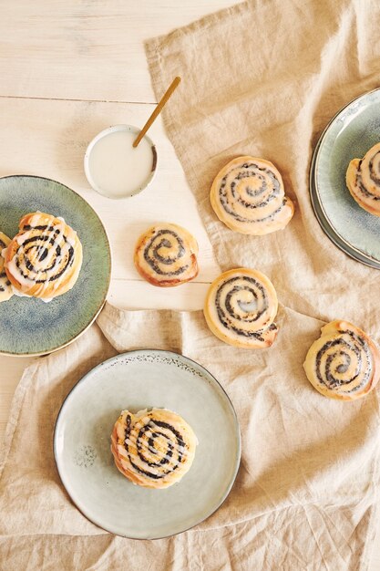 Vertical shot of poppy seed rolls with sugar glaze