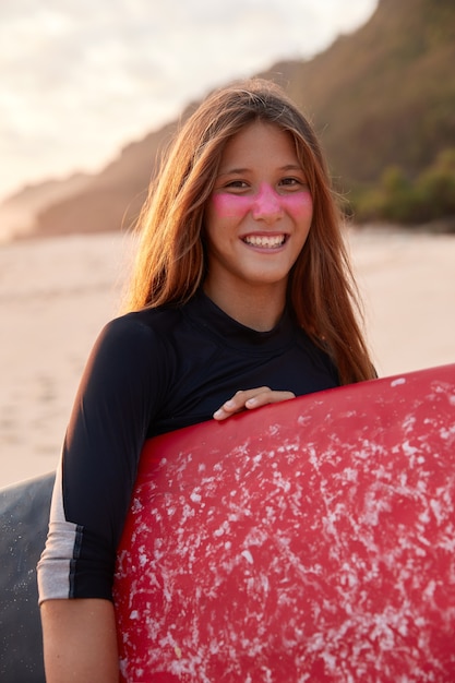 Vertical shot of pretty smiling woman with appealing appearance