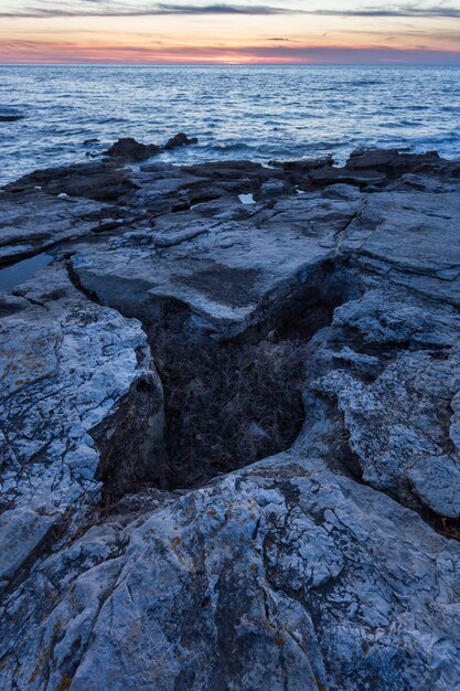Vertical shot of rock formations at the Adriatic sea in Savudrija, Istria, Croatia