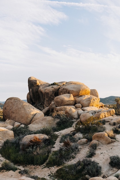 Vertical shot of rock formations on a mountain under the sunlight