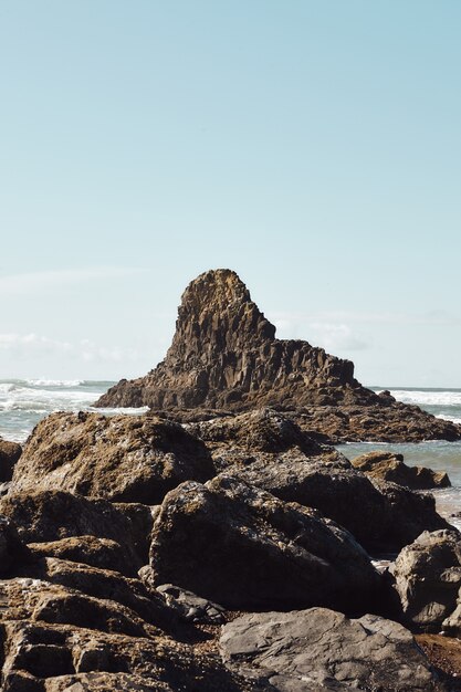 Vertical shot of rocks at the coastline of the Pacific Northwest in Cannon Beach, Oregon