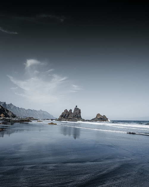 Vertical shot of rocks formations in the water of the sea