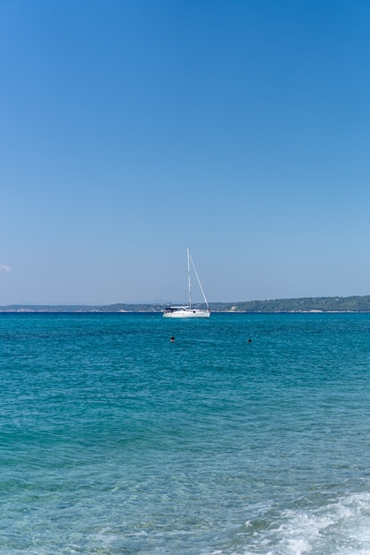 Vertical shot of a sailboat in the sea