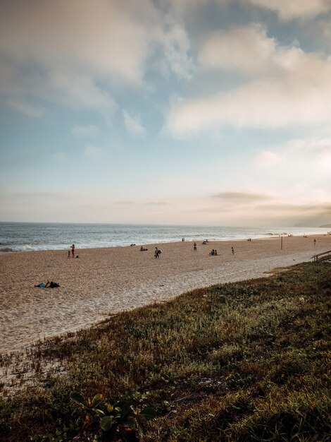 Vertical shot of a sandy beach in Rio, Brazil on a cloudy day