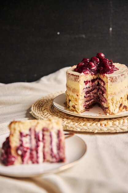 Vertical shot of the sliced cherry cake in the distance