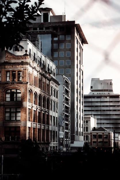 Vertical shot of some beautiful buildings captured through some fences