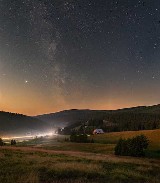 Vertical shot of a starry night sky with the Milky Way over the Giant Mountains