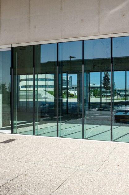 vertical shot of the transparent doors of a commercial building