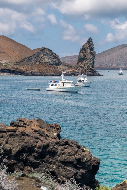 Vertical shot of two yachts sailing in the ocean at Galapagos Islands, Ecuador