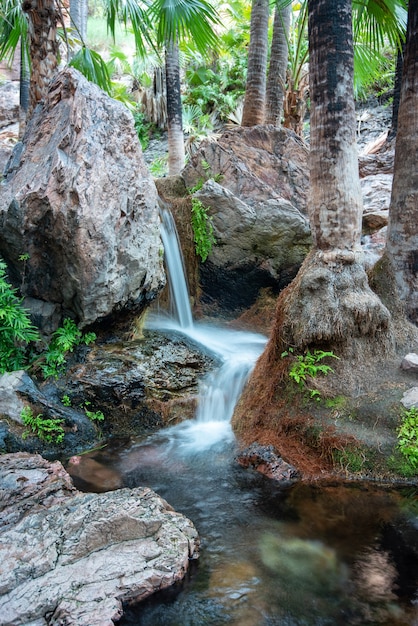 Vertical shot of water tumbled down in a series of mini-waterfalls