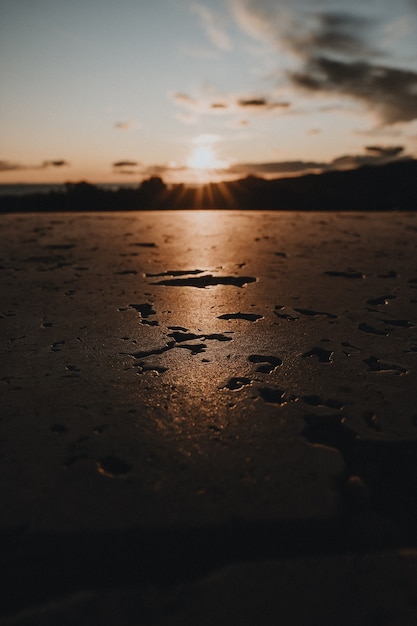 Vertical shot of a wet surface reflecting the sunlight