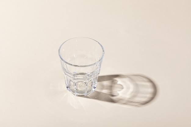 Vertical shot of a whiskey glass with shadow