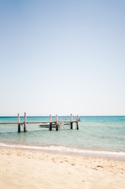 Vertical shot of a white dock on the body of water