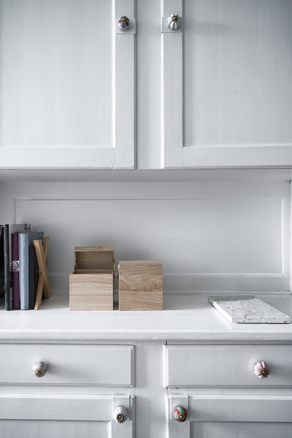 Free photo vertical shot of white furniture with shelves inside a room