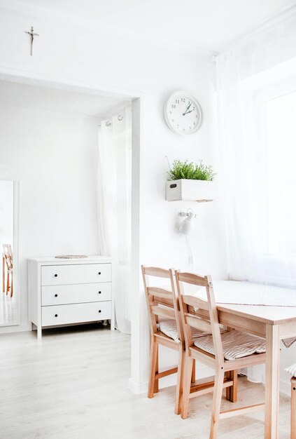 Vertical shot of a white interior with wooden elements