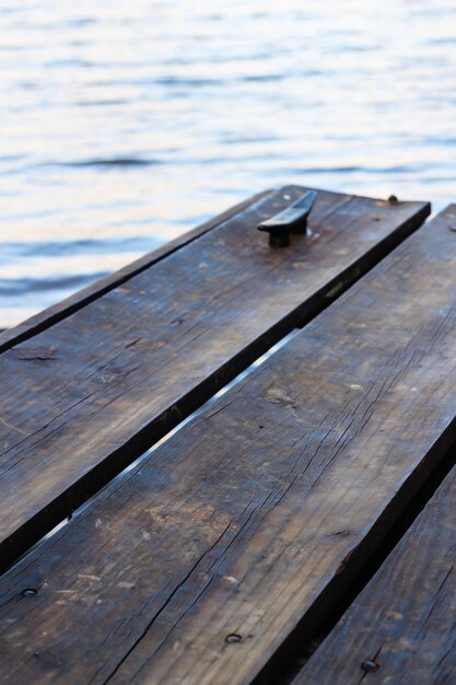 Vertical shot of wooden boats above the water