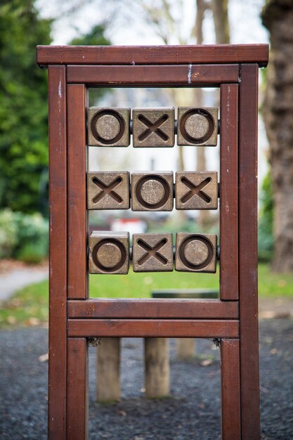 Vertical shot of wooden tic-tac-toe in the park