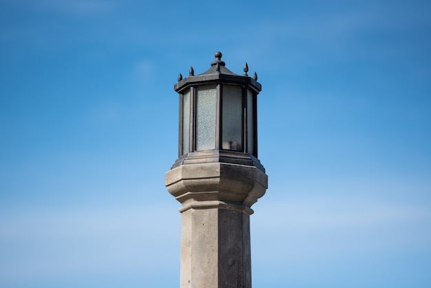 Vertical of a street light post against the blue sky