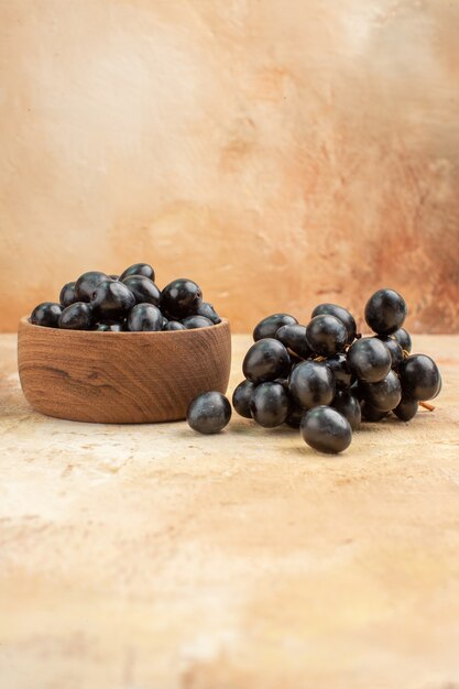 Vertical view of black fresh grapes in small pots and