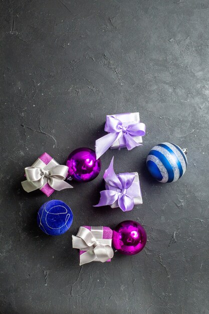 Vertical view of colorful gifts and decoration accessories on black background