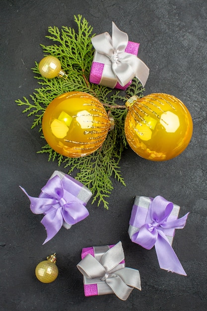 Vertical view of colorful gifts and decoration accessories on dark background