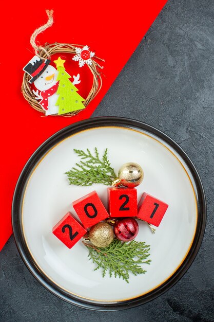 Vertical view of decoration accessories numbers on a plate on a dark table