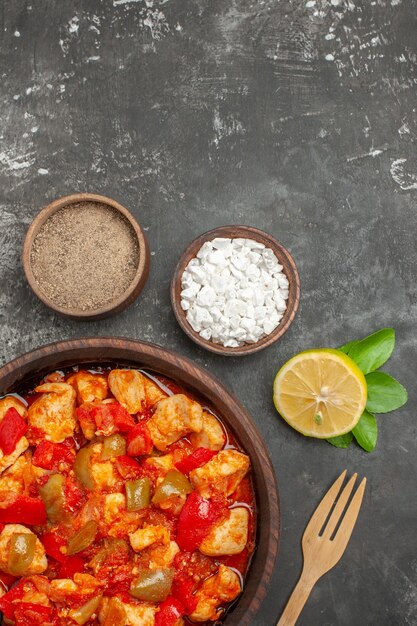 Free photo vertical view of delicious chicken soup different spices lemon