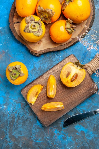 Vertical view of delicious whole and cut diospyros kaki