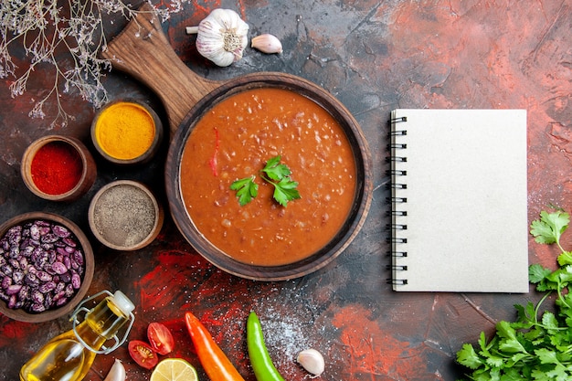 Vertical view of dinner background fallen oil bottle beans cutting board and different spices