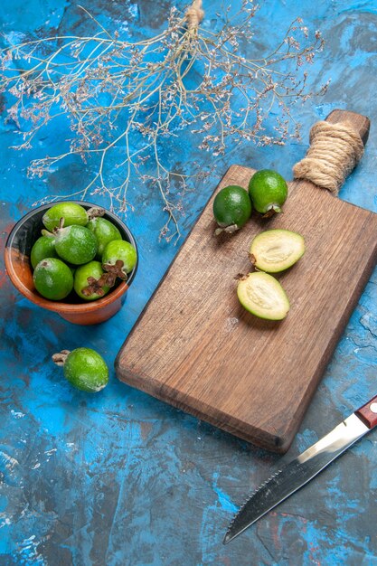 Vertical view of fresh natural delicious cut and whole green feijoas