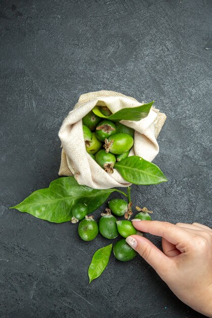 Vertical view of natural fresh green feijoas in a white bag