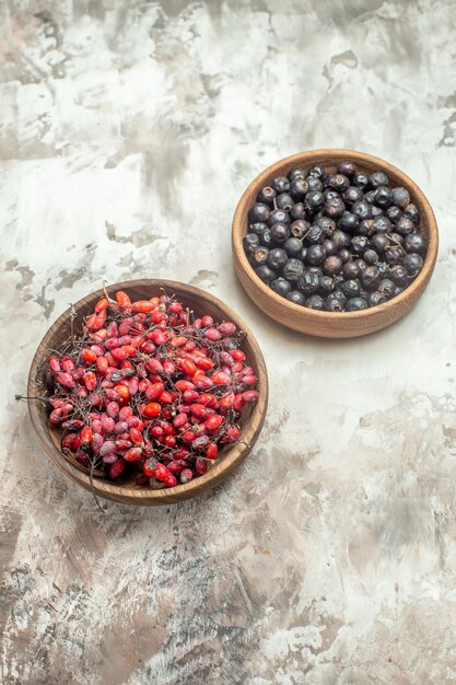 Vertical view of natural and fresh various fruits in small brown wooden pots