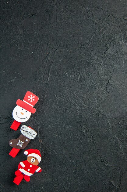 Vertical view of new year decoration accessories lined in a row on the right side on black surface