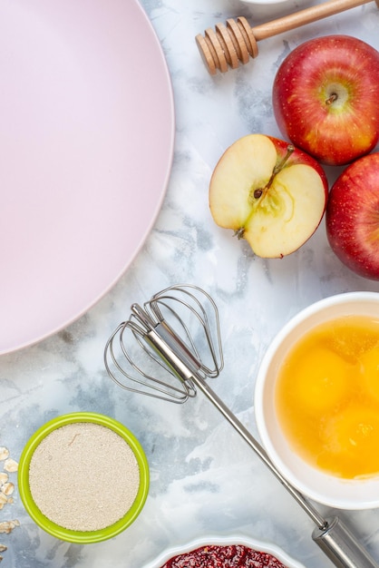 Vertical view of white plate and fresh healthy food set on two-toned background