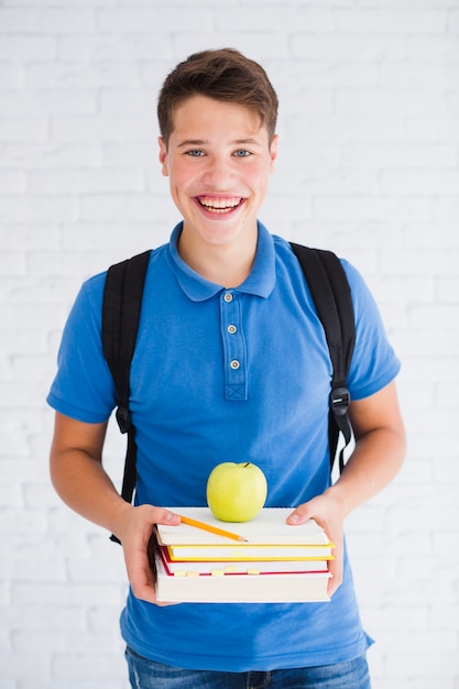 Very happy teenager with textbooks