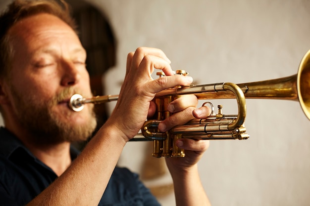 Free photo veteran musician playing the trumpet