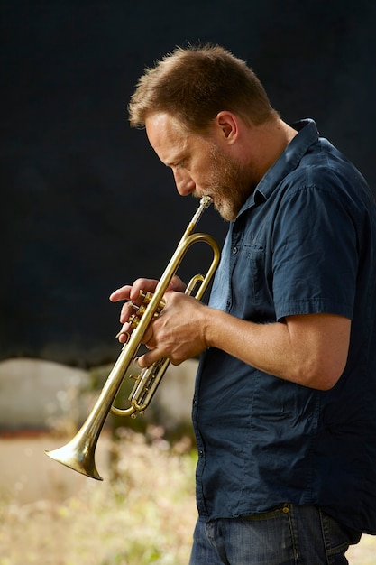 Free photo veteran musician playing the trumpet