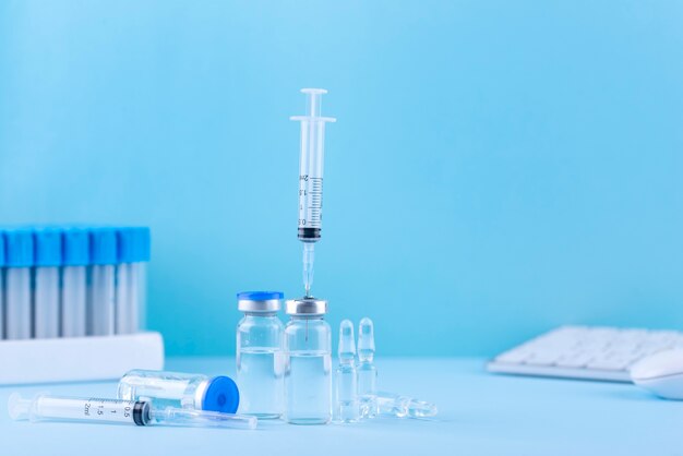 Vials and syringes with blue background