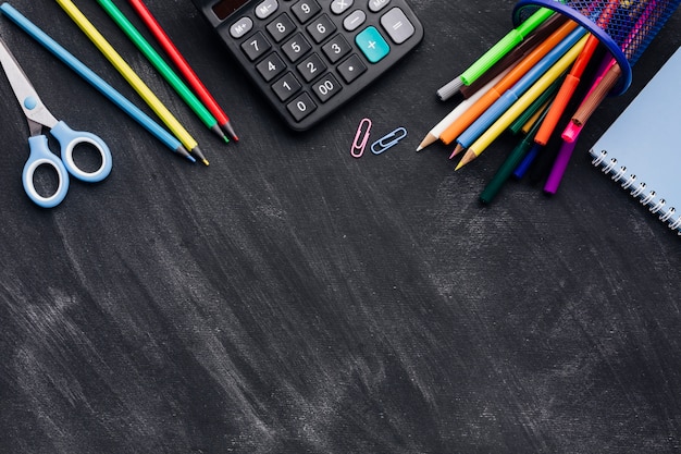 Vibrant stationery and calculator  on grey background